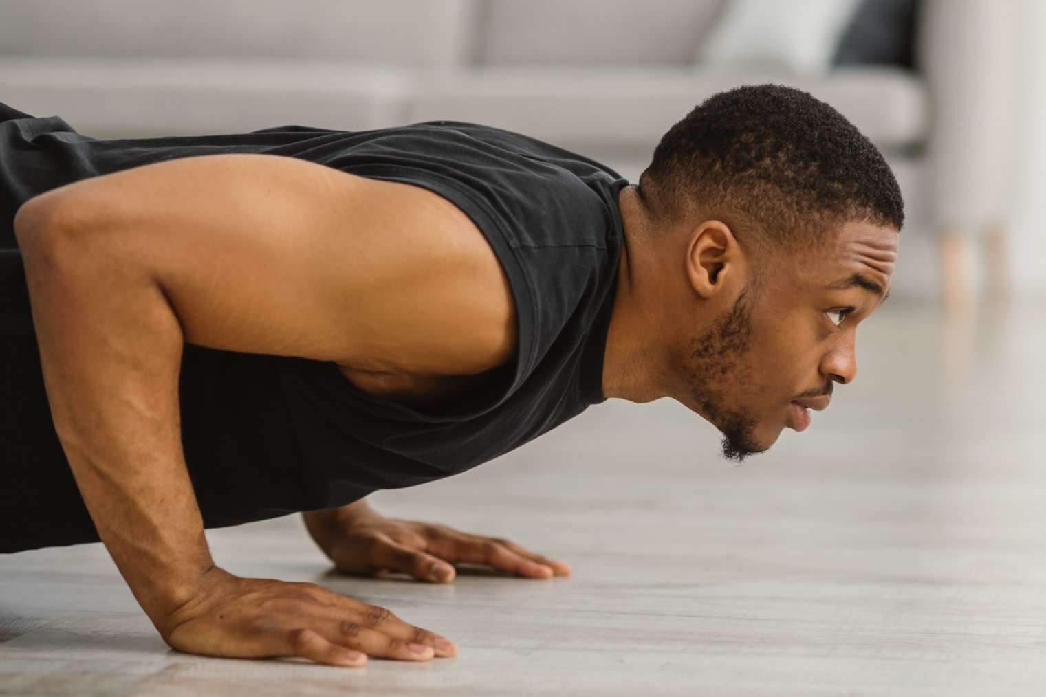 A close-up photo of a man doing a push-up.