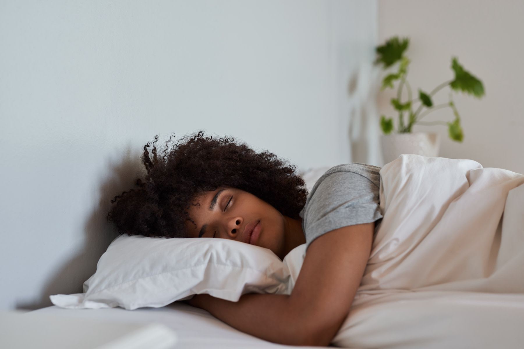 A woman peacefully sleeping in bed.