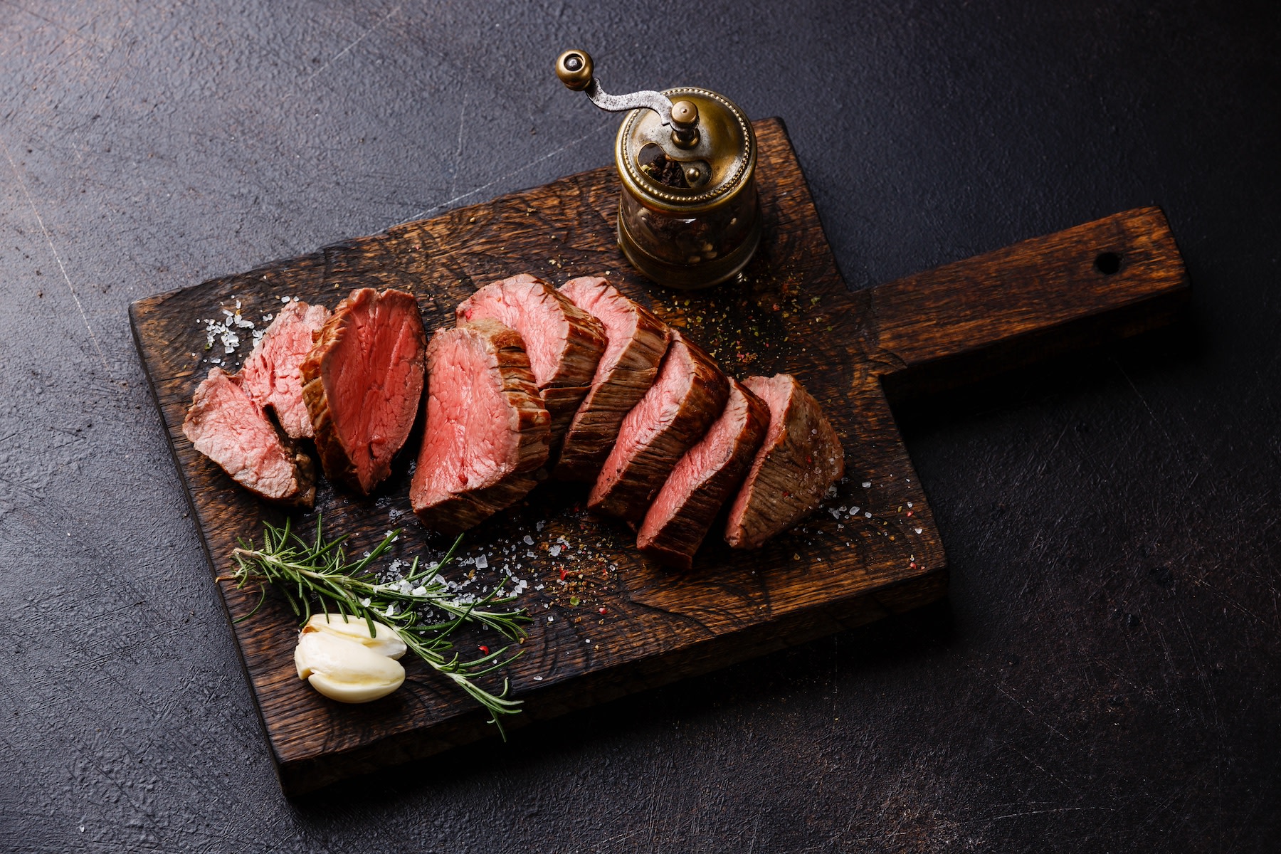 Sliced roast beef tenderloin, a lean protein, on a cutting board.