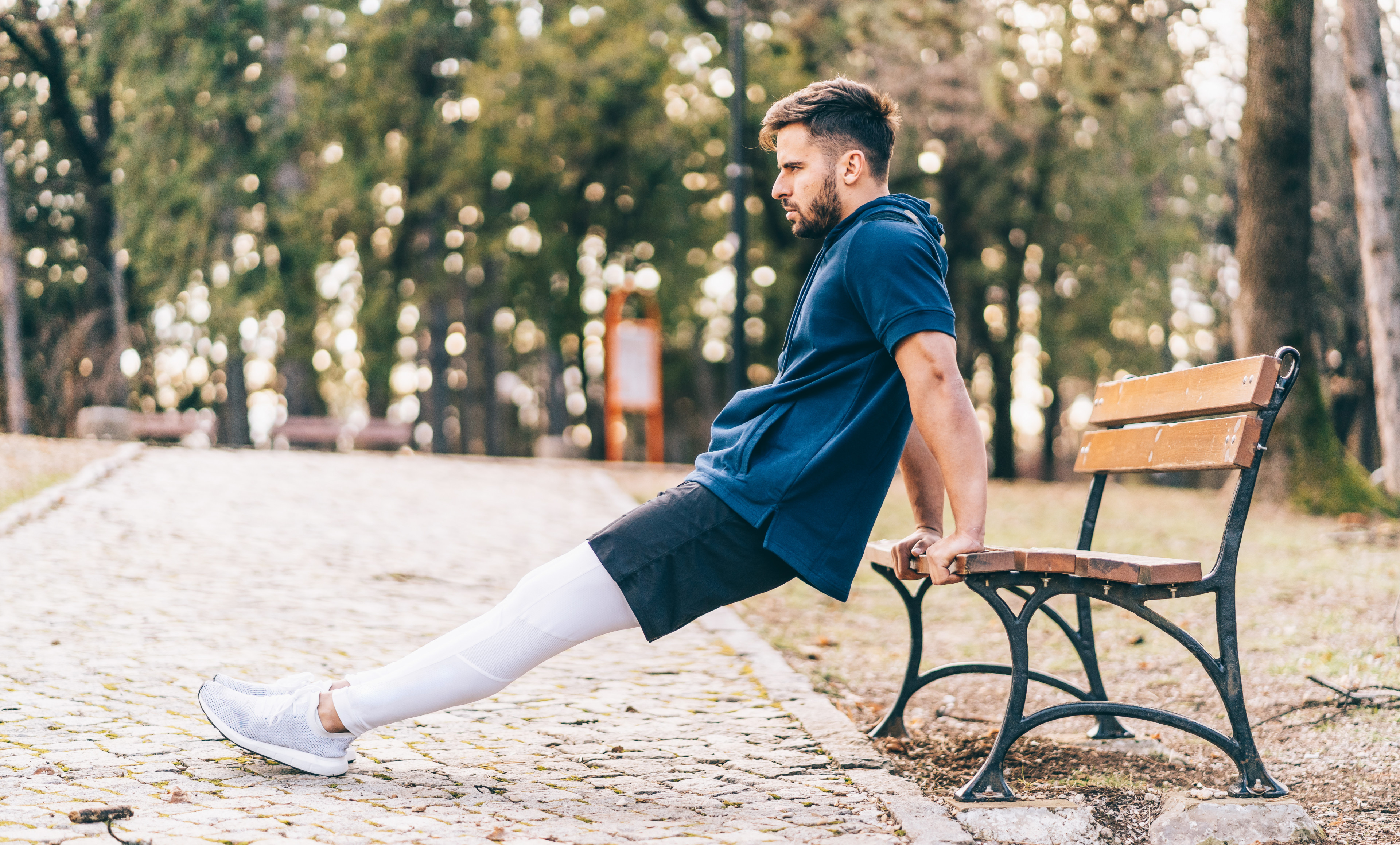 Man doing Tricep Dips in park 