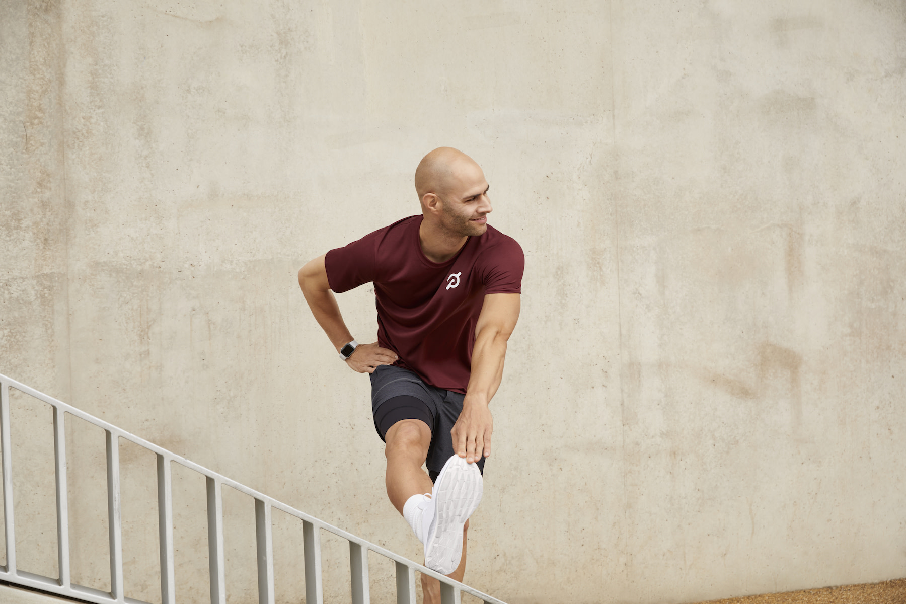 Man reaches towards toe to stretch hamstring 