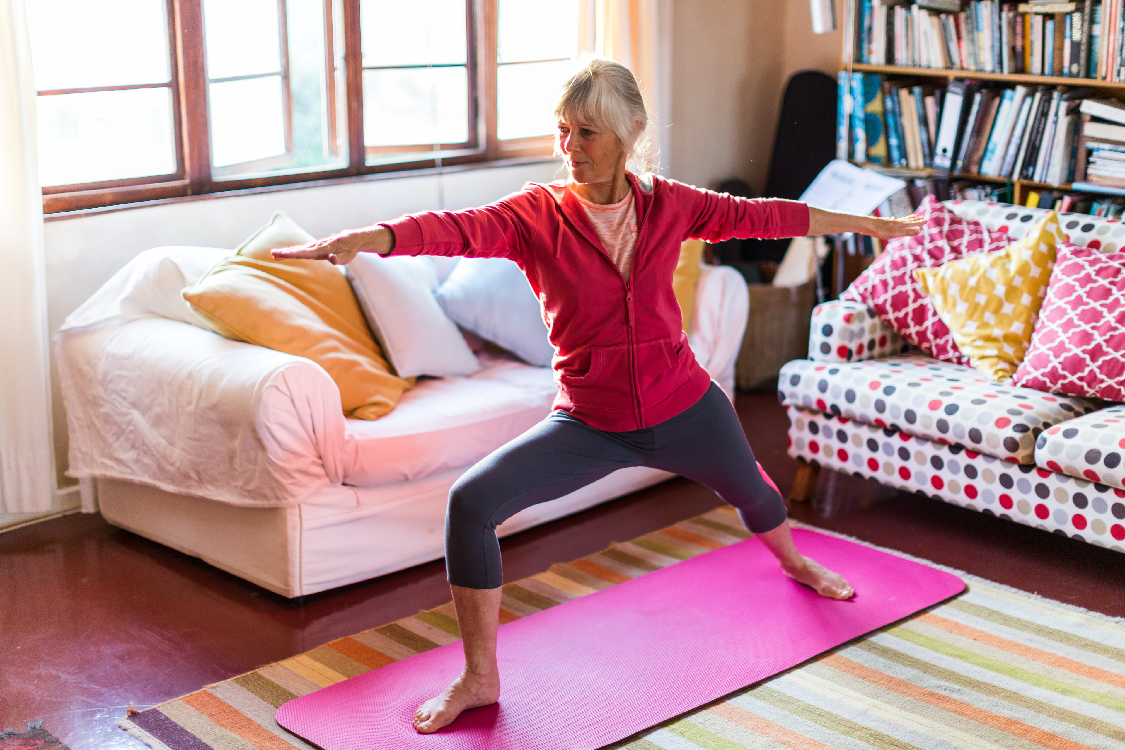 Woman practices yoga at home 