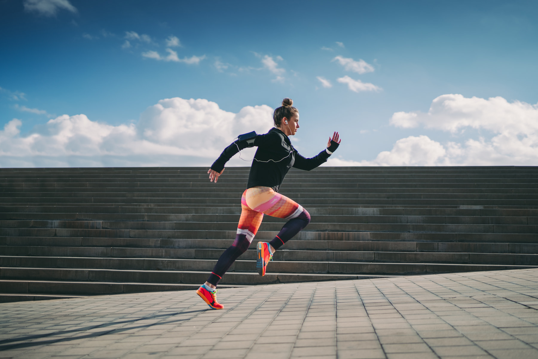 Woman practices bounding while running, a plyometric exercise