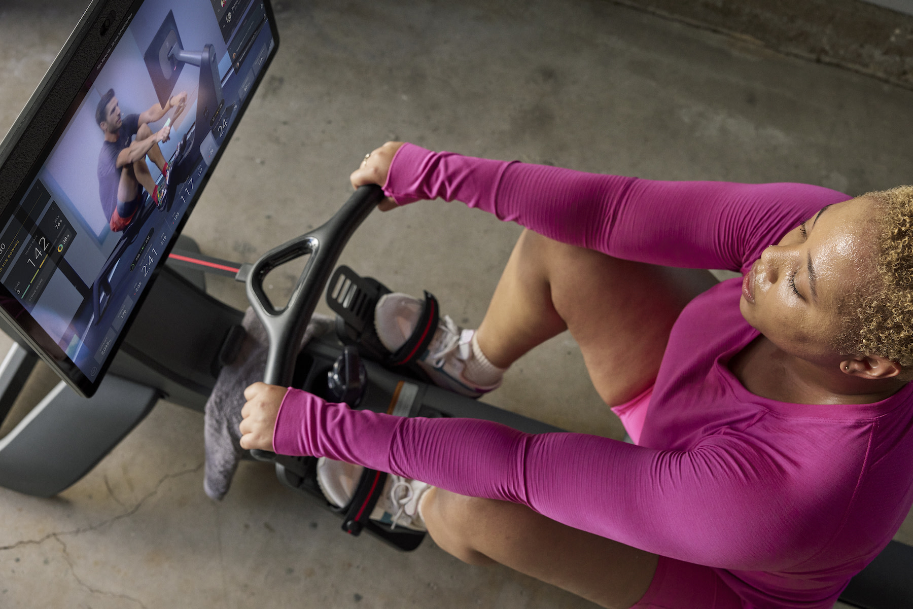 woman warming up on rowing machine