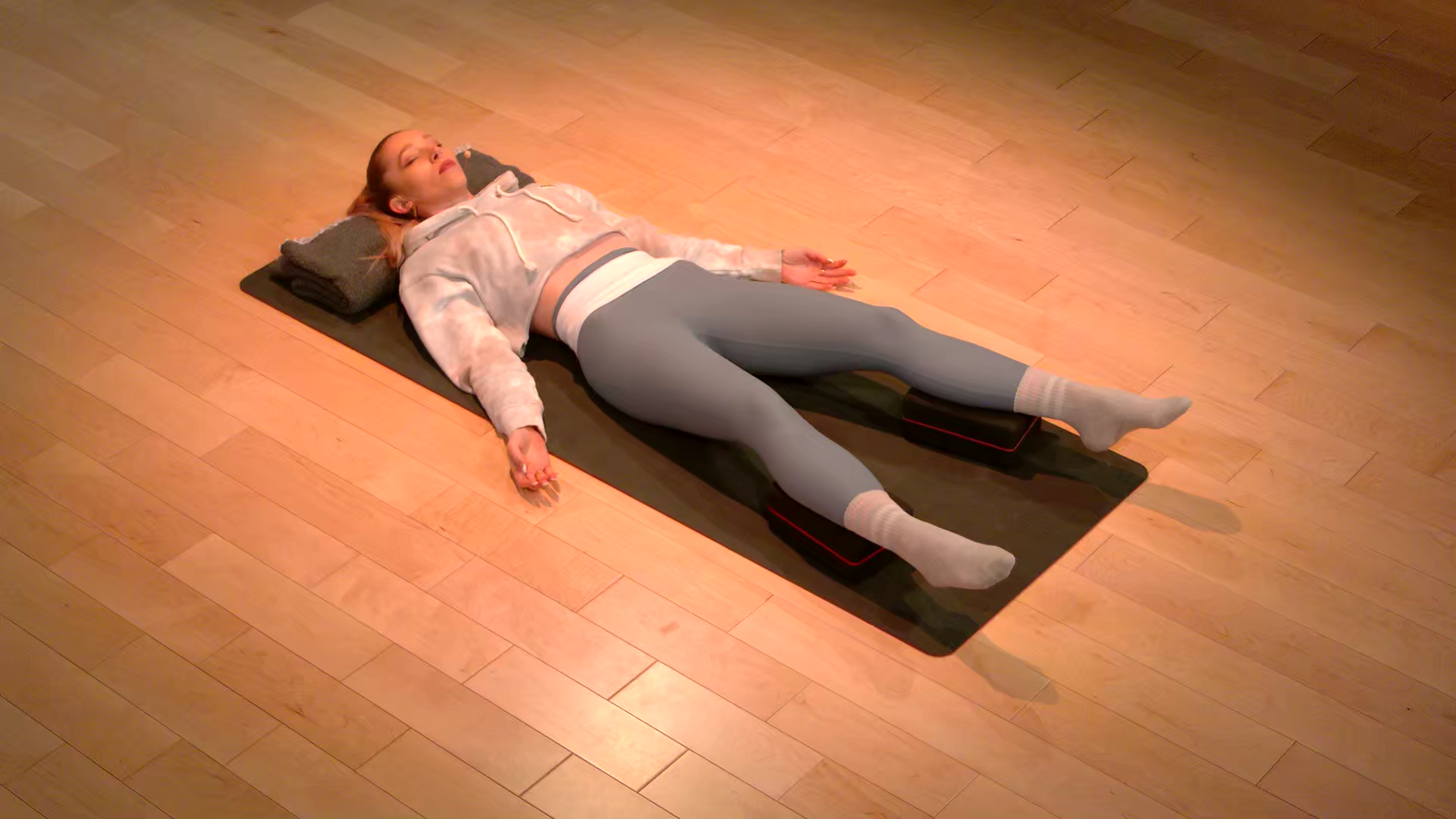 Peloton instructor Kirra Michel in Corpse Pose (Savasana)