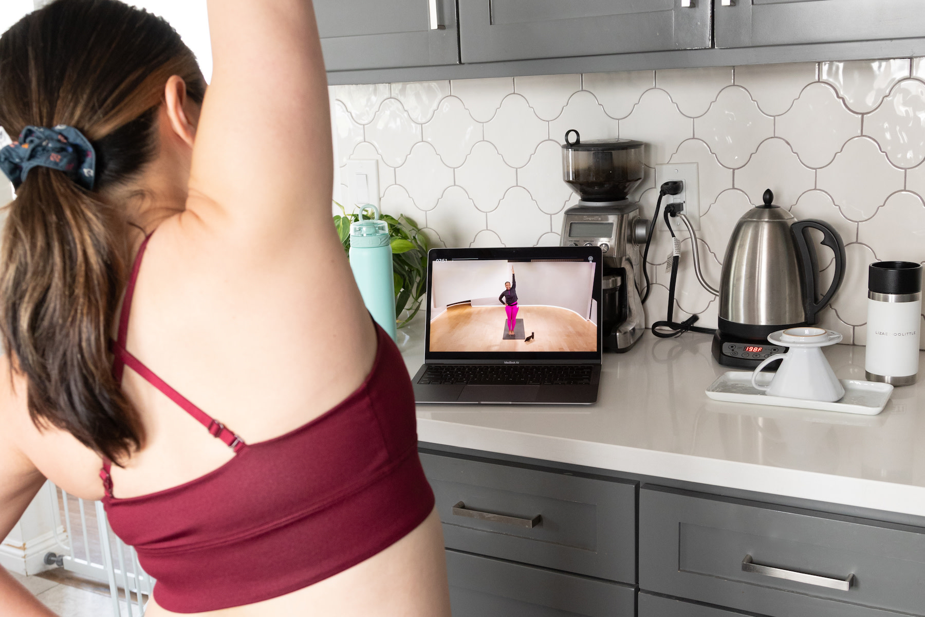 Woman does Peloton Bike workout at home.