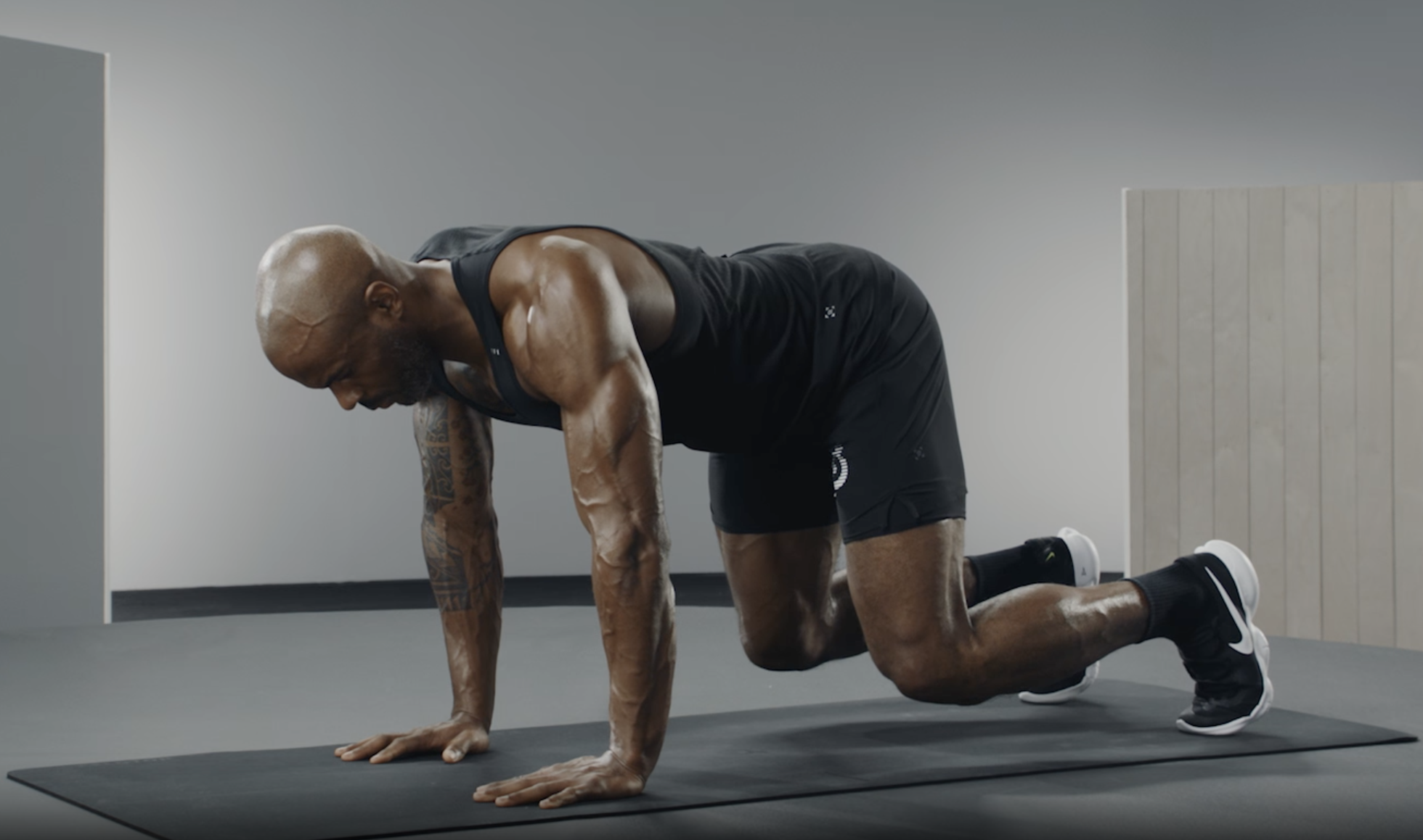 Adrian Williams demonstrates a bear plank exercise