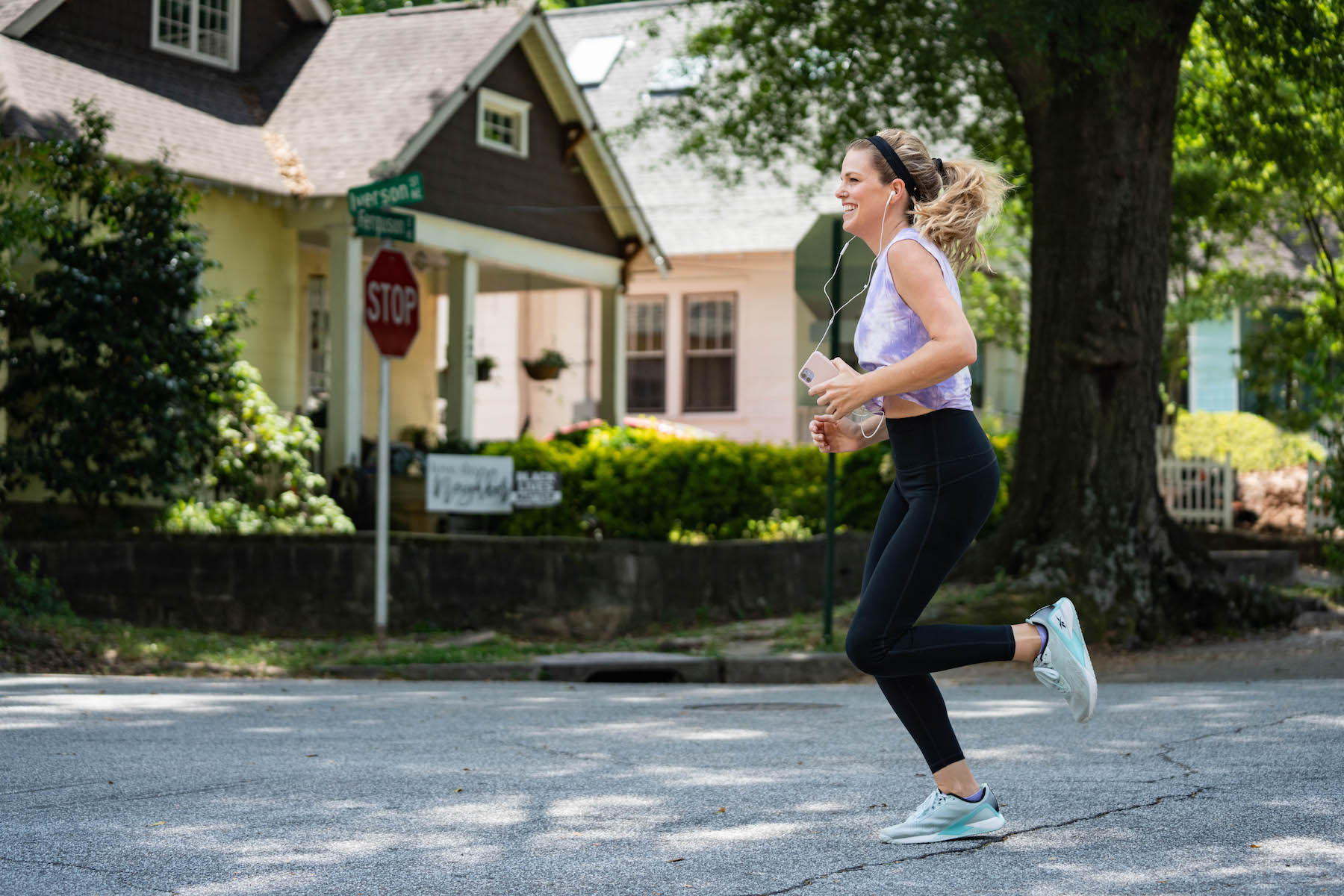 Woman running outside with headphones