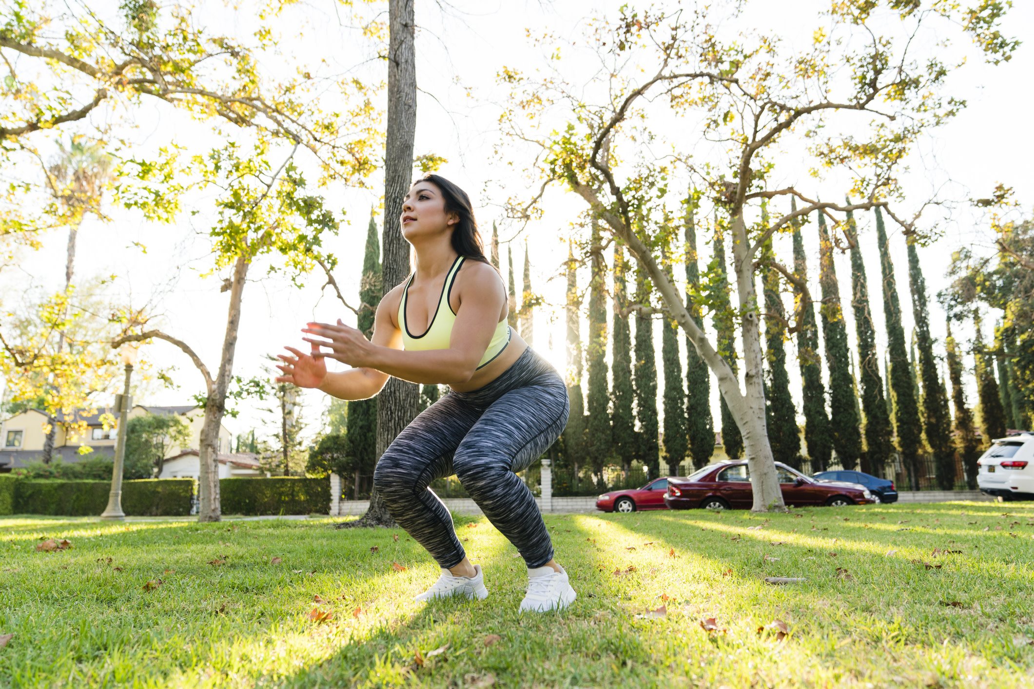 Woman does a jump squat outdoors 