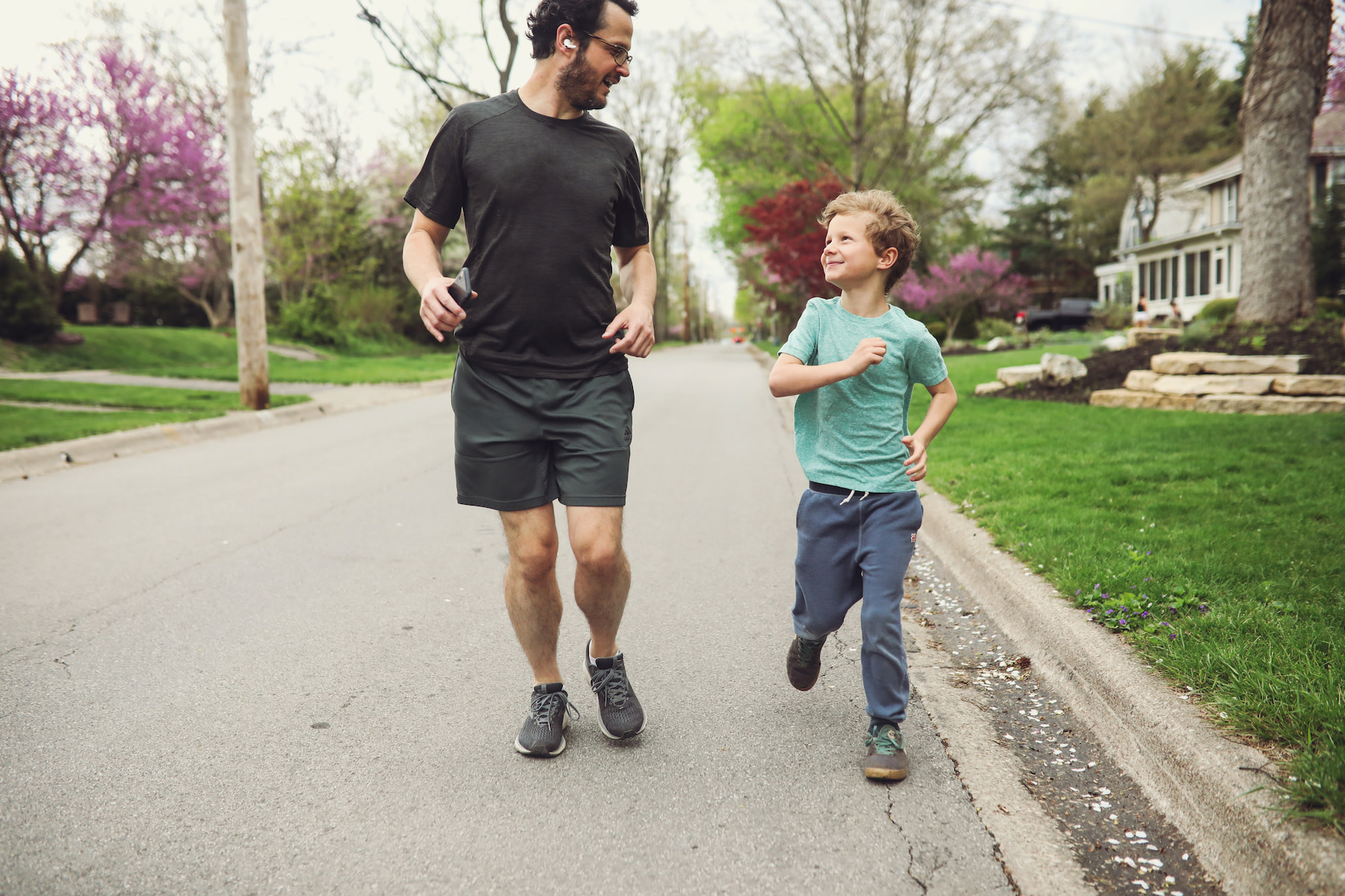 Father and son walk together outside 