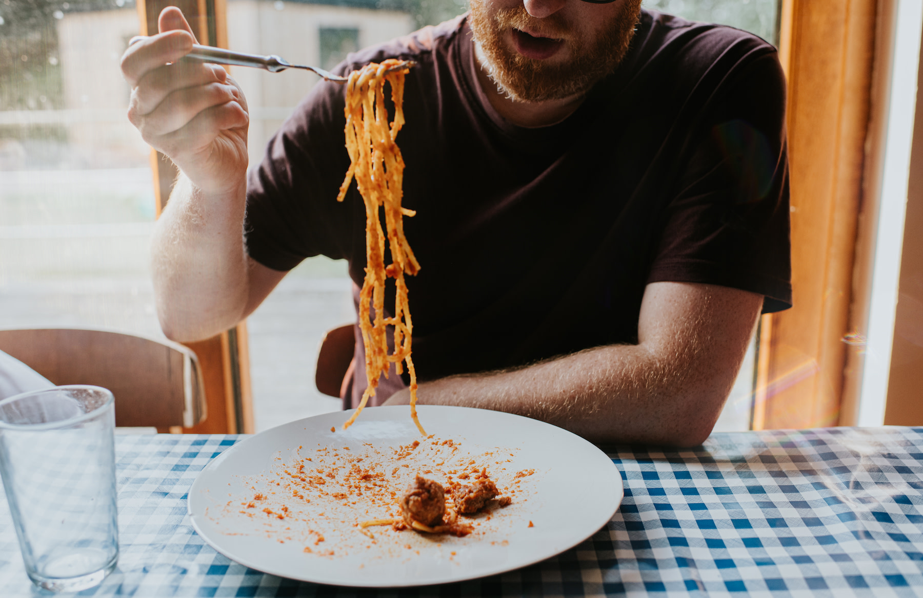 A man carb loading with a plate of spaghetti.