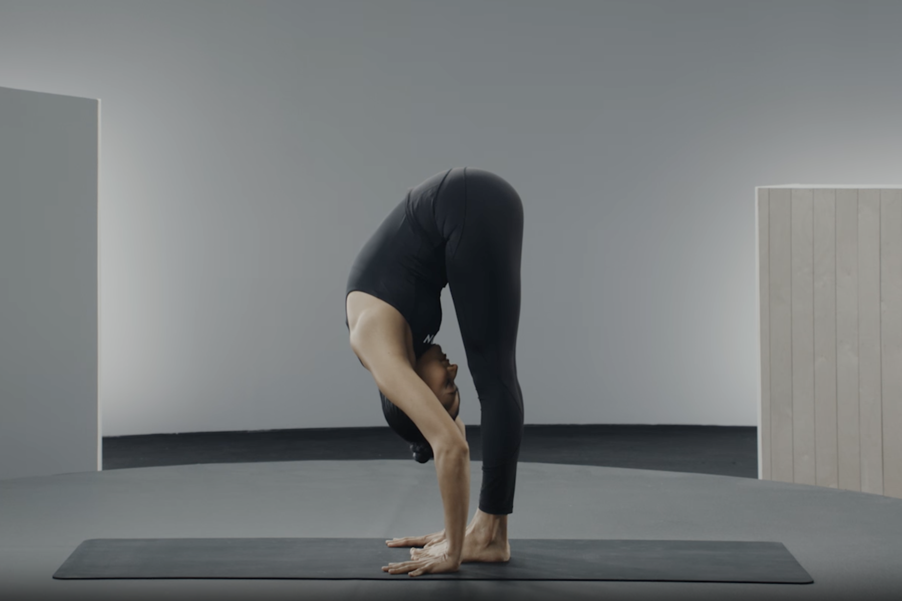 Woman does a Standing Forward Fold, a gentle yoga pose