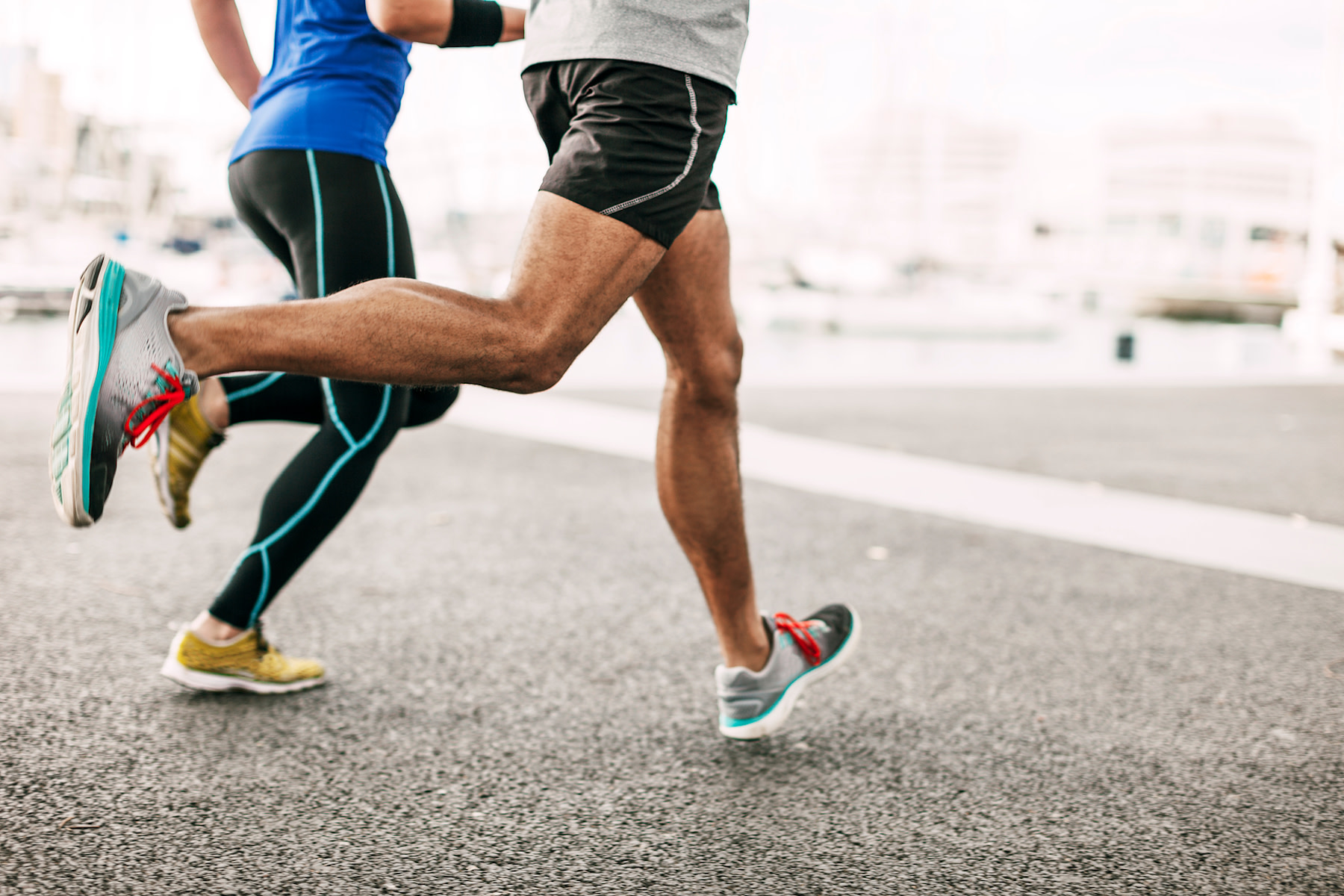 Couple runs outside on pavement