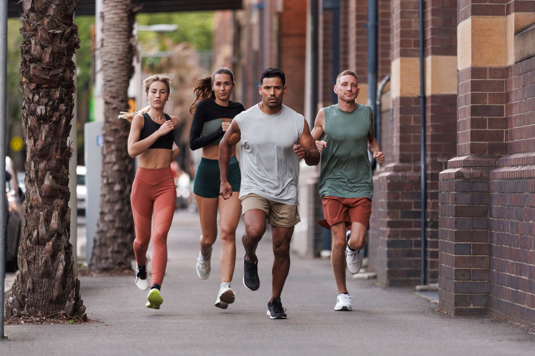 Two men and two women running outside