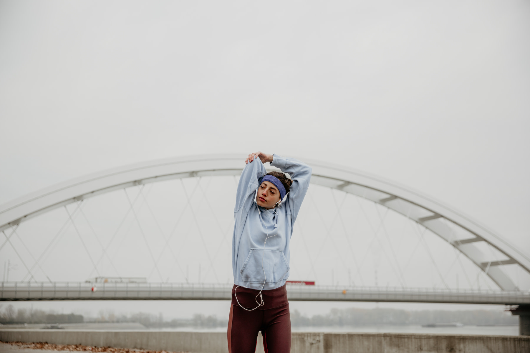 Woman does shoulder mobility exercises outside