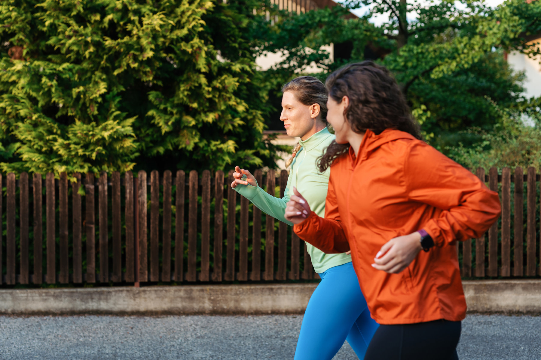 Two women jog together, practicing zone 2 cardio