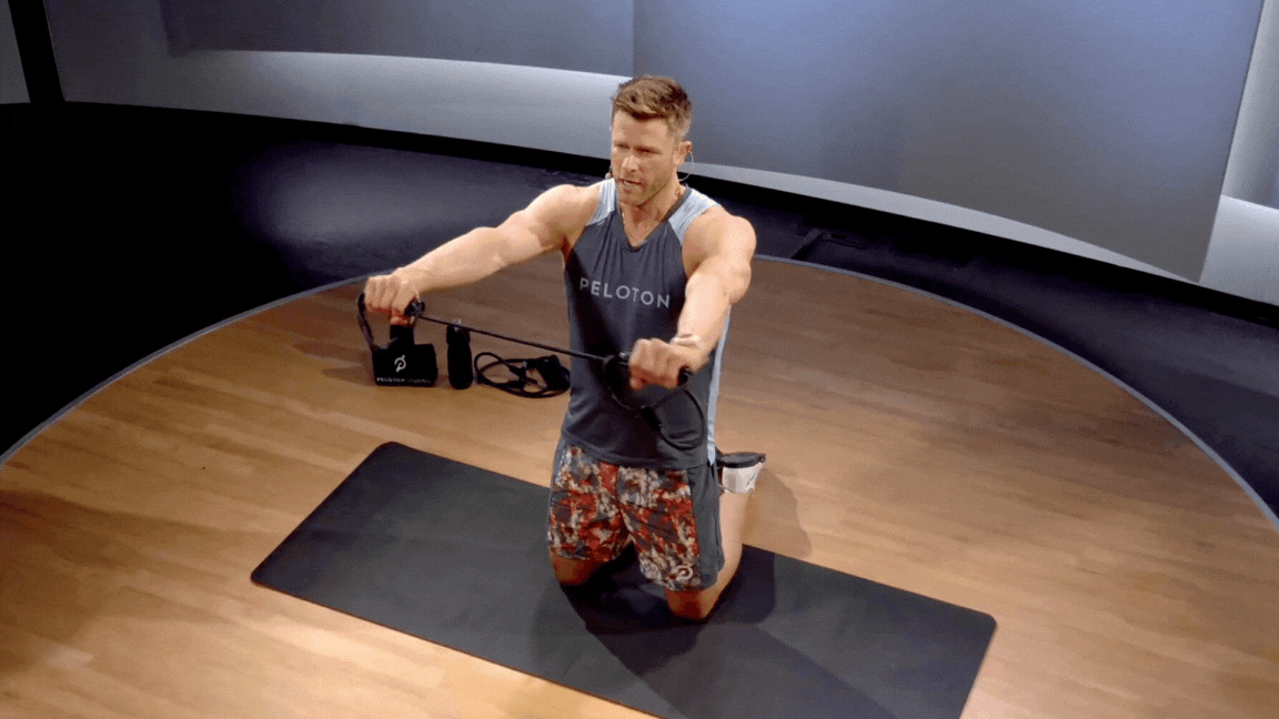 Peloton instructor Andy Speer demonstrates the resistance band pull-apart rear delt exercise.