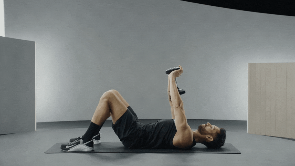 Peloton instructor Matty Maggiacomo demonstrates a dumbbell pullover lat exercise with proper form