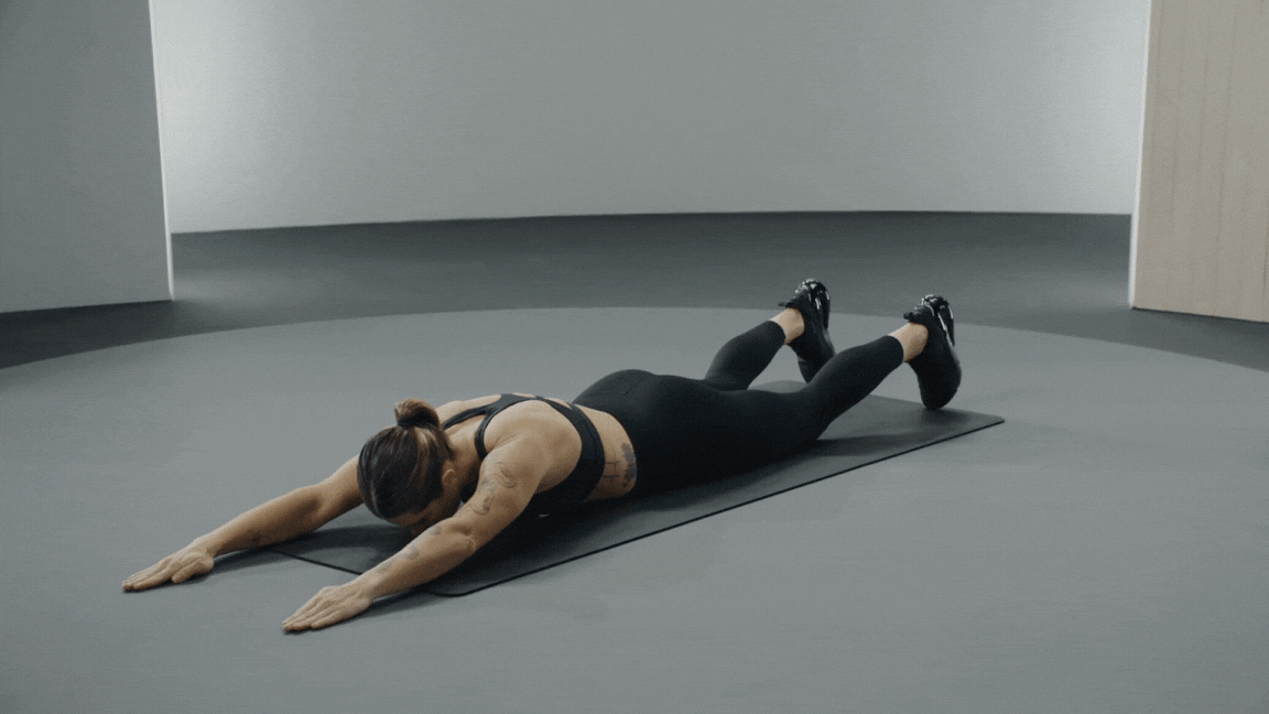 Peloton instructor Selena Samuela demonstrates a prone IYWT warm-up exercise.