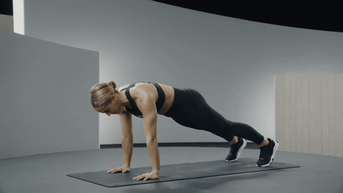 Peloton instructor Jess Sims demonstrates mountain climbers as a warm-up exercise.