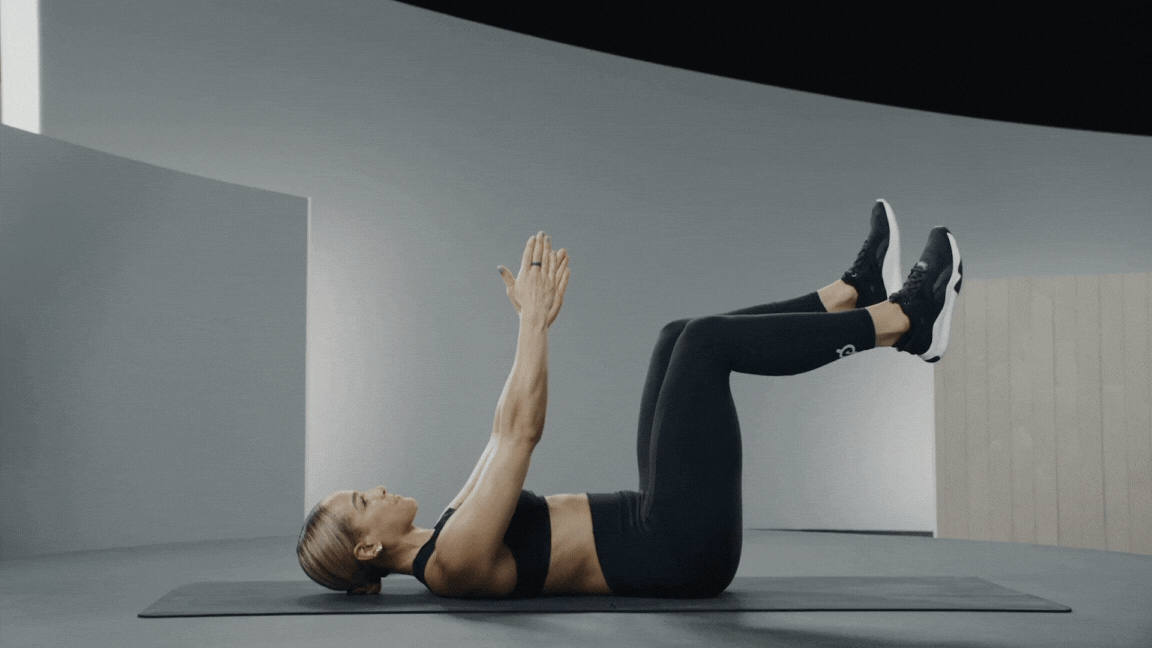 Peloton instructor Jess Sims demonstrates the dead bug oblique exercise