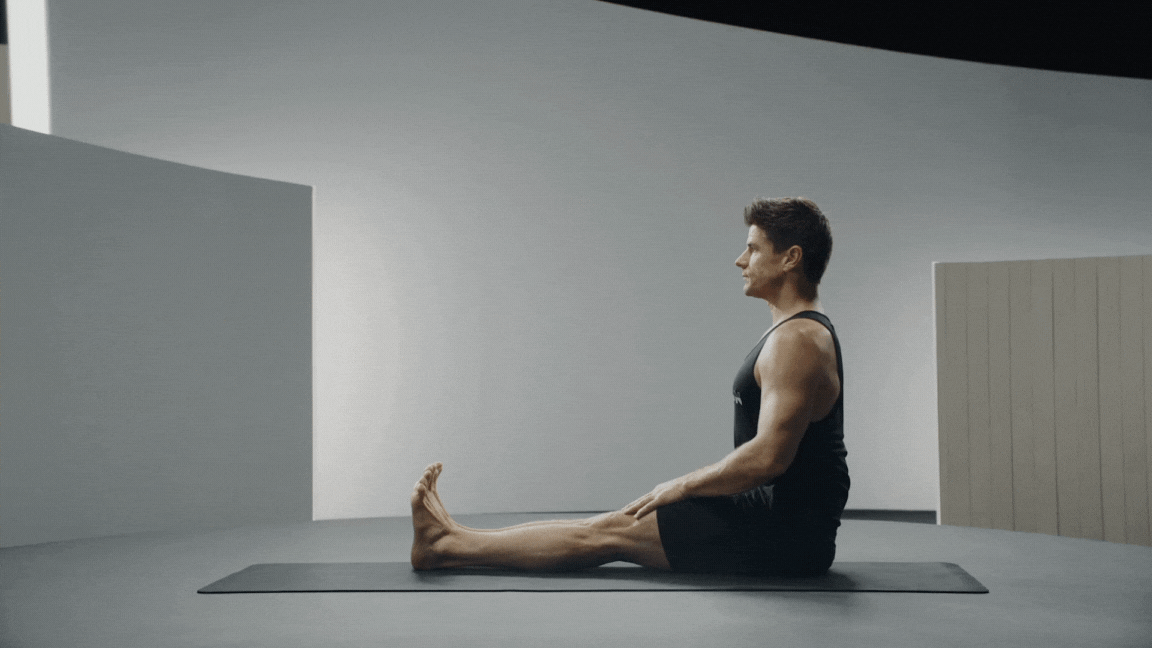 Peloton instructor Denis Morton demonstrating Head to Knee Pose 