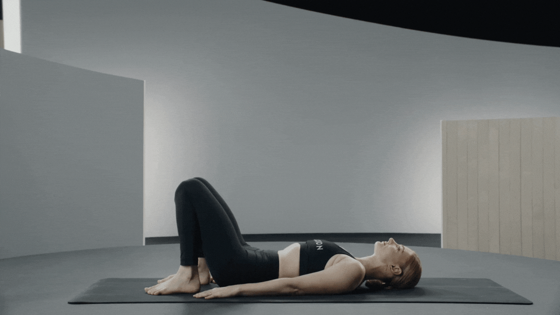 Peloton instructor Anna Greenberg demonstrates yoga backbend Wheel Pose with proper form