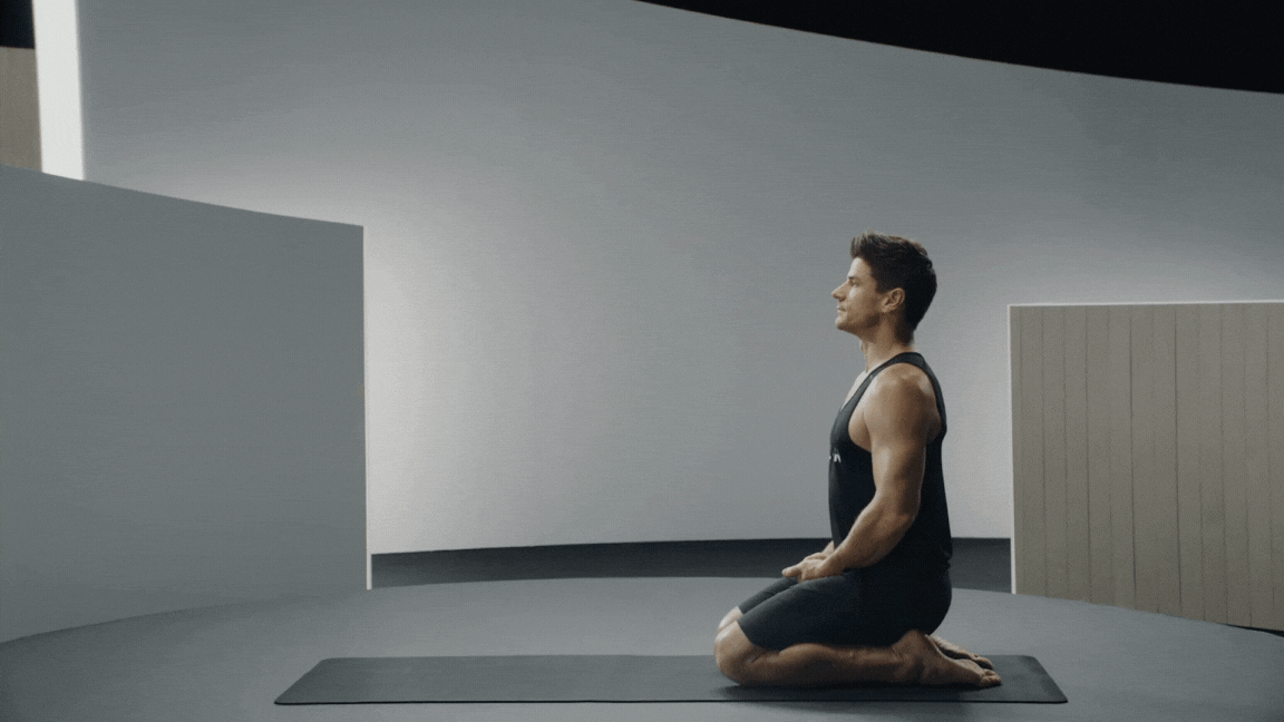 Peloton instructor Denis Morton demonstrates yoga backbend Camel Pose with proper form