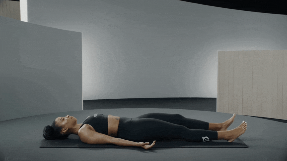 Peloton instructor Chelsea Jackson Roberts demonstrating a supine twist.