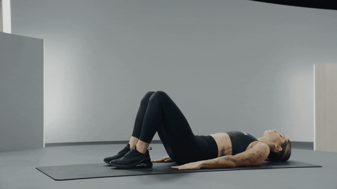 A Peloton instructor demonstrates the bridge walkout hamstring exercise