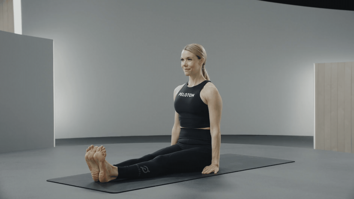 Kristin McGee doing a spine twist upper back stretch.