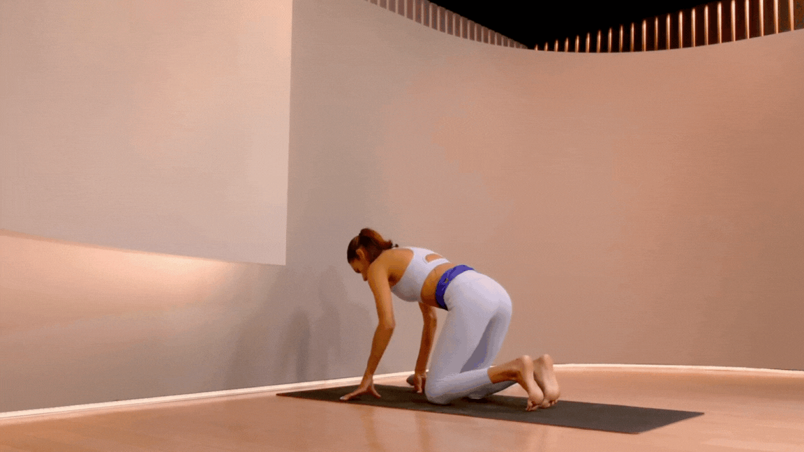 Peloton instructor Aditi Shah demonstrating a yoga headstand