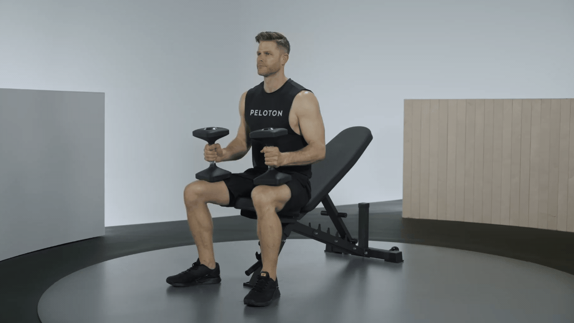 Andy Speer demonstrates a dumbbell incline chest press exercise on workout bench