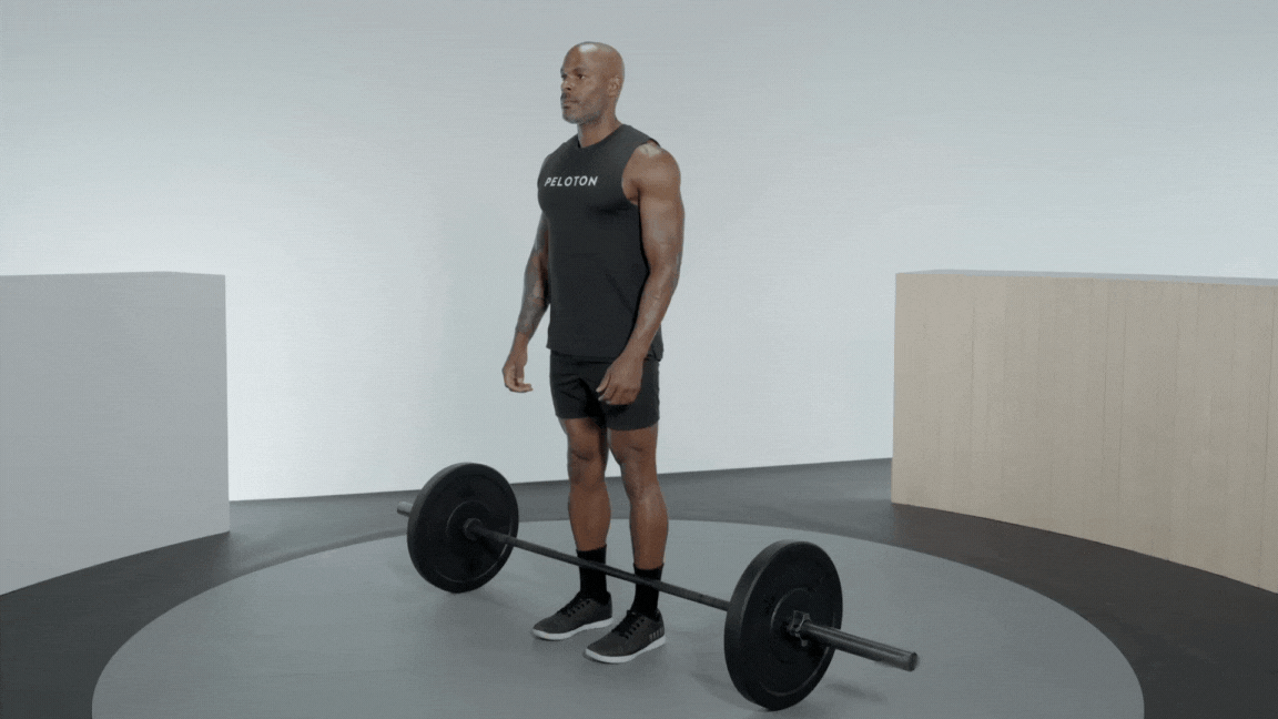 Peloton instructor Adrian Williams demonstrates a barbell Romanian deadlift (RDL) with proper form