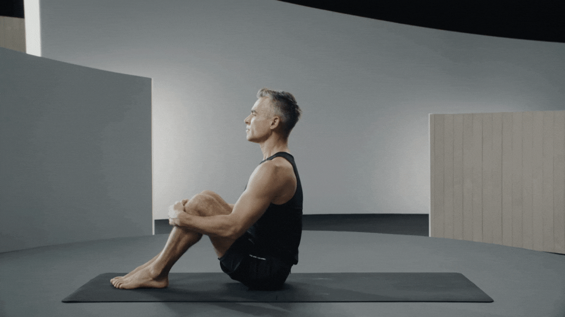 Peloton instructor Ross Rayburn demonstrates yoga backbend Fish Pose with proper form