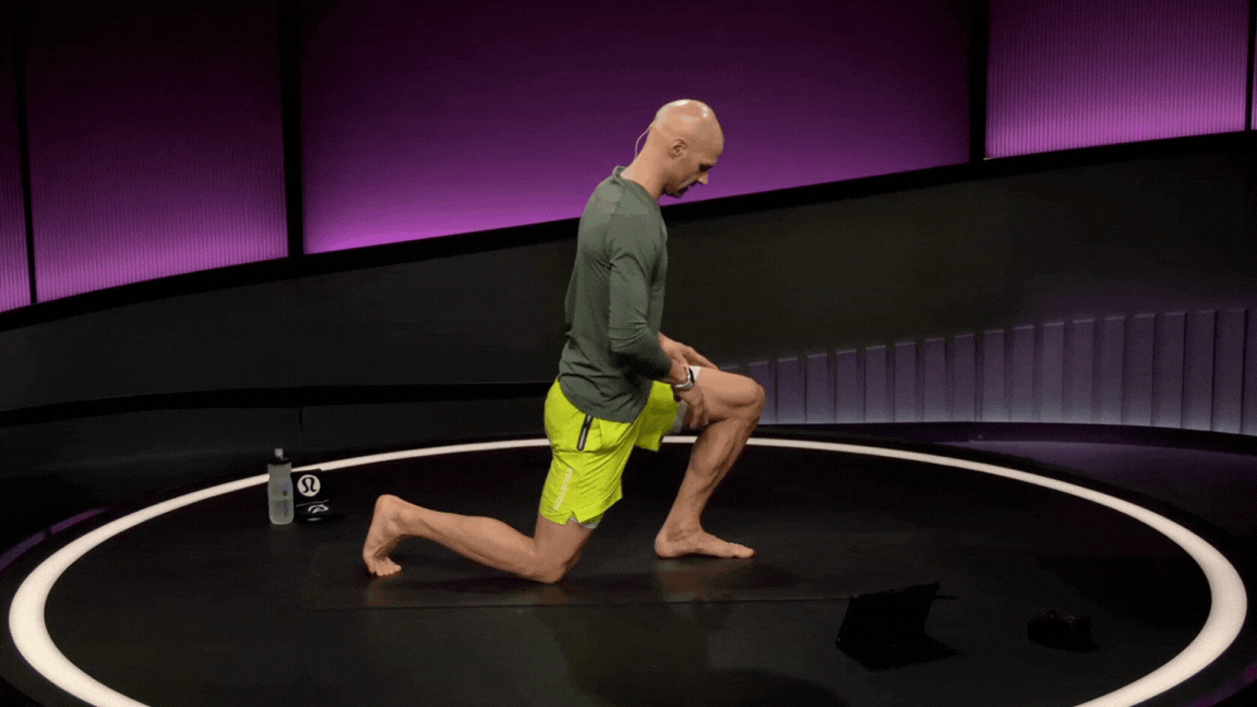 Peloton instructor Marcel Maurer demonstrates a kneeling dorsiflexion stretch during a foot and ankle mobility class