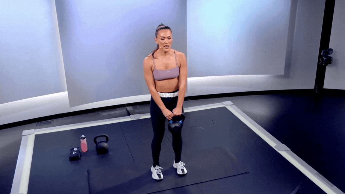 Peloton instructor Katie Wang demonstrates the kettlebell around the world exercise as part of a list of kettlebell shoulder exercises