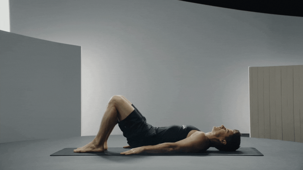 Peloton instructor Denis Morton demonstrates Supine Figure Four or Reclined Pigeon Pose as a yoga pose for flexibility.