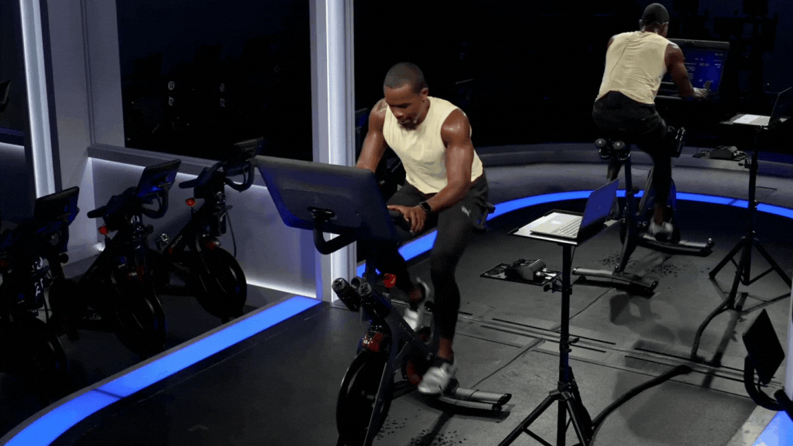 Peloton instructor Alex Toussaint leads a cycling workout warm-up. 