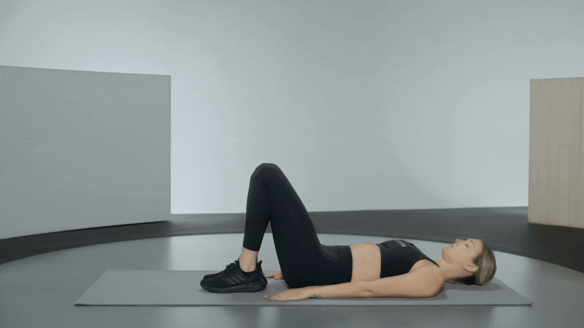 Peloton instructor Callie Gullickson demonstrates a leg lift or leg raise exercise 