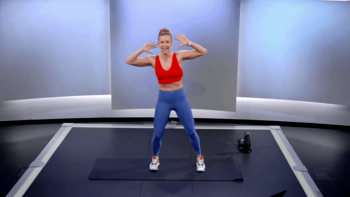 Peloton instructor Rebecca Kennedy demonstrates a standing side crunch oblique exercise