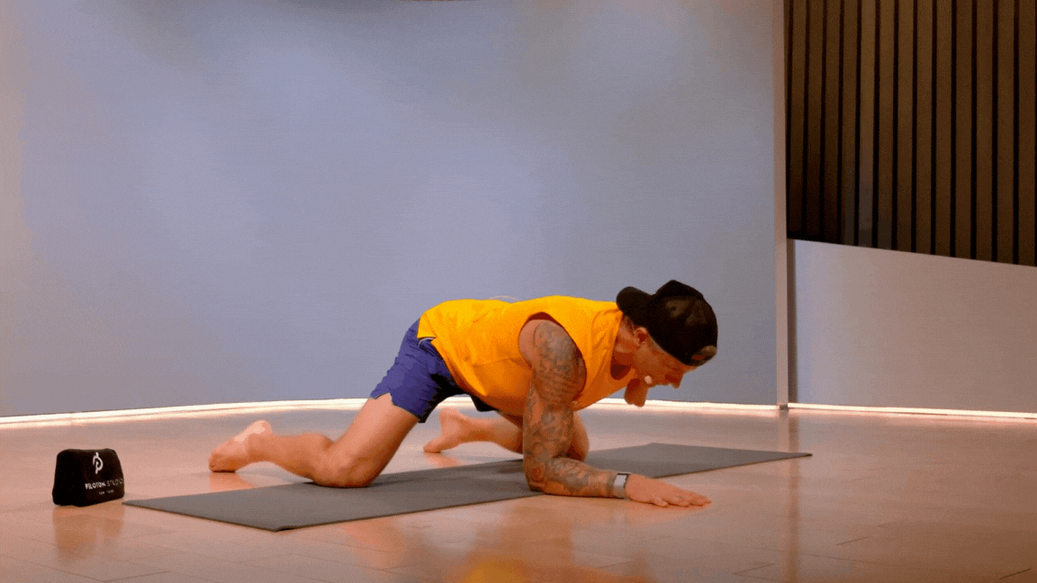 Logan Aldridge demonstrates how to do a frog stretch in Peloton class