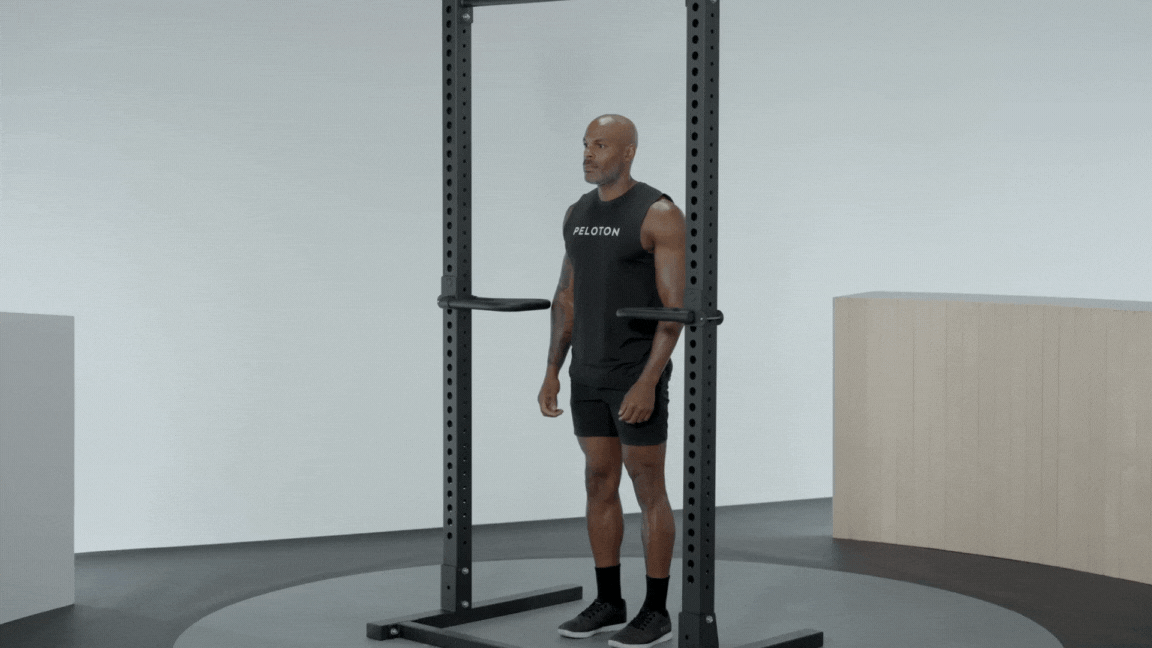 Peloton instructor Adrian Williams demonstrates bodyweight dips with proper form as a bench press alternative