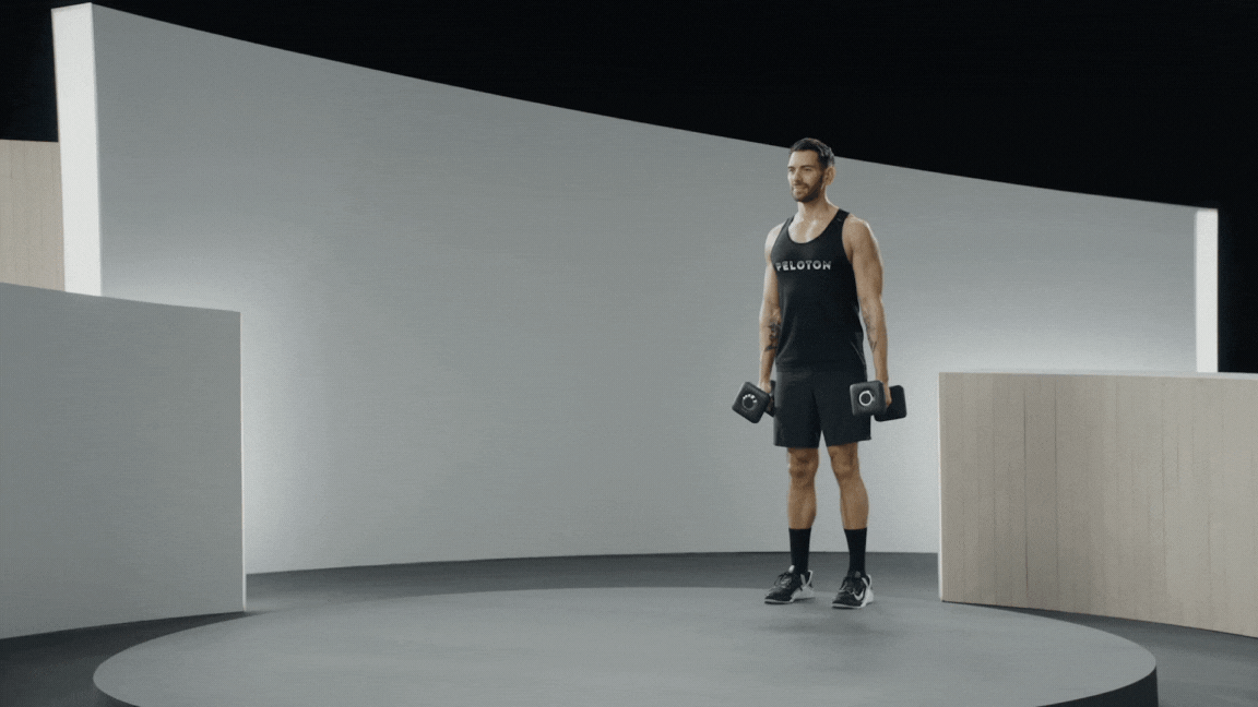 Peloton instructor Matty Maggiacomo demonstrates a farmer's carry with proper form