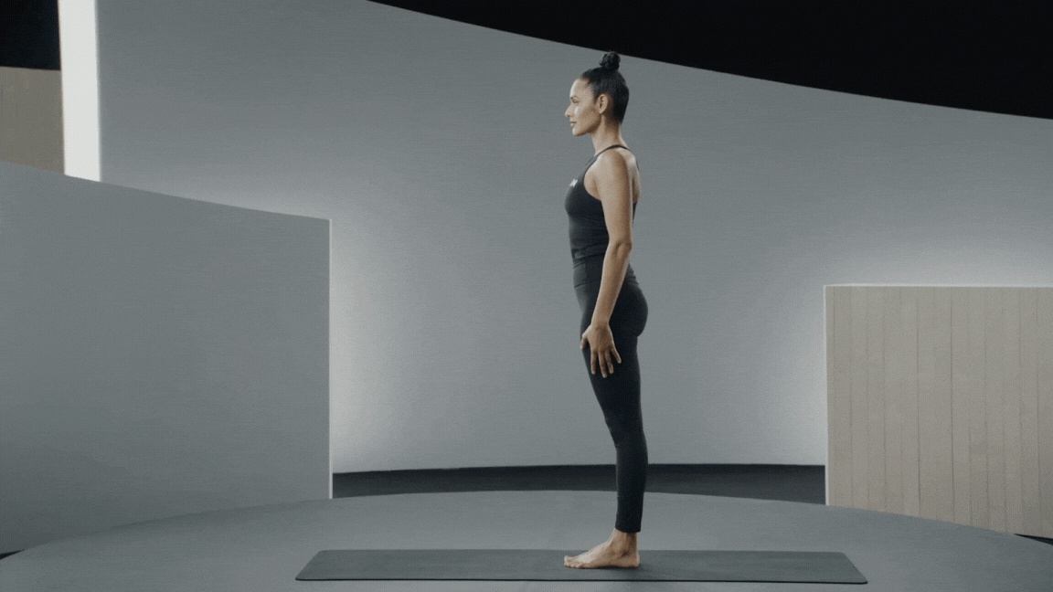 Peloton instructor Aditi Shah demonstrates a standing forward fold as an easy yoga pose.