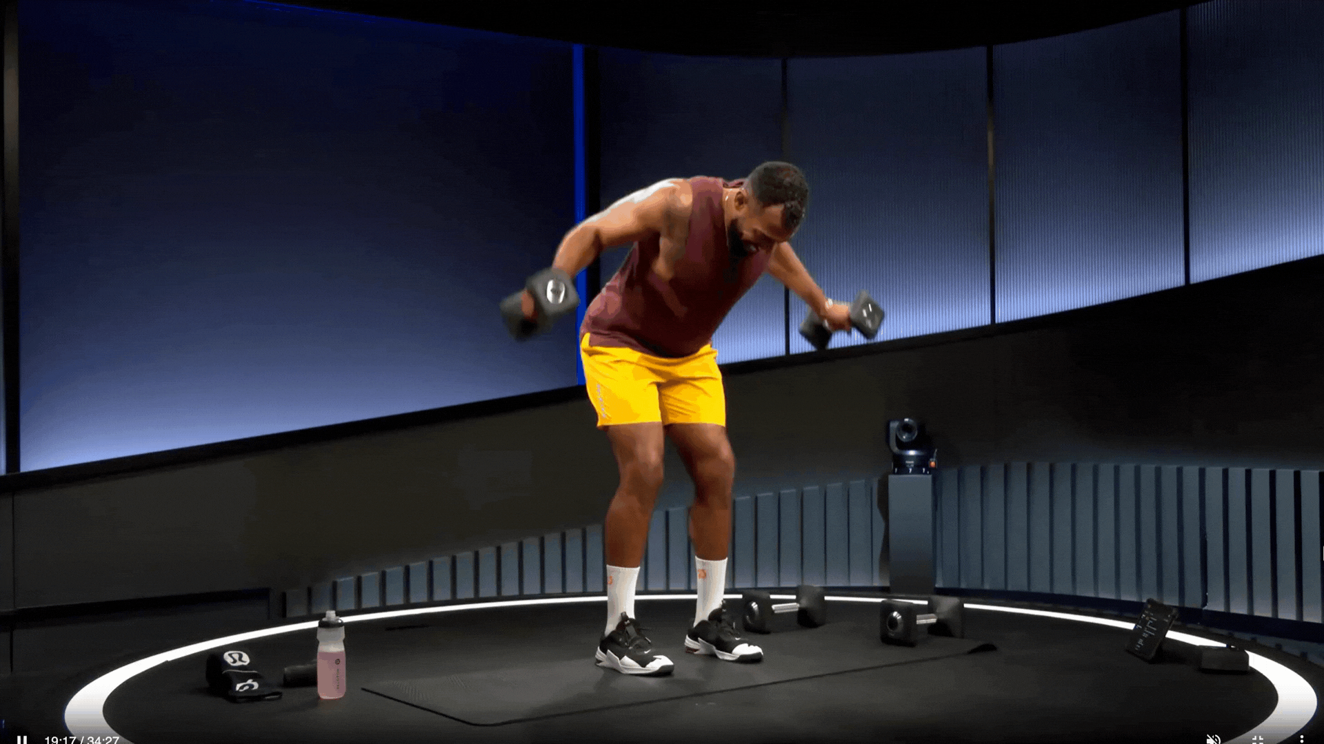 Man does a reverse fly, a dumbbell shoulder exercise