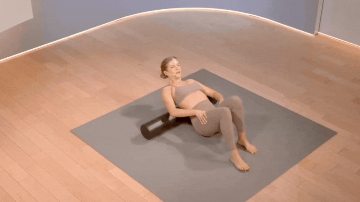 Peloton instructor Rebecca Kennedy demonstrates lumbar foam rolling during a Peloton foam rolling class.