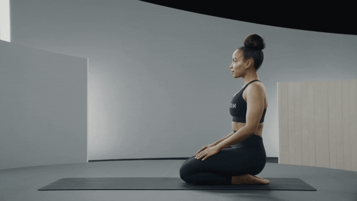 Peloton instructor Chelsea Jackson Roberts demonstrates Downward-Facing Dog yoga pose for flexibility.