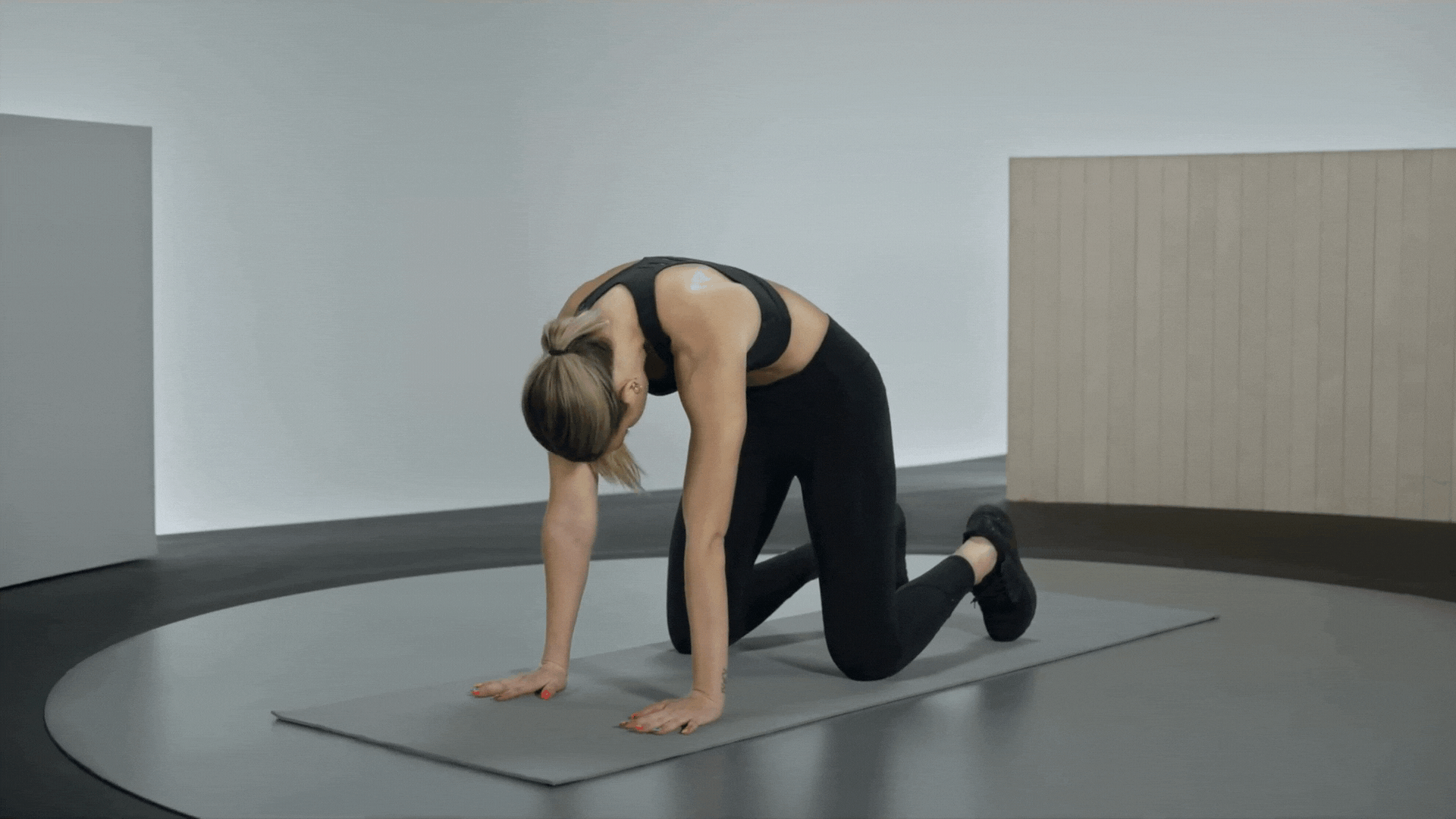 Woman moves through Cat-Cow