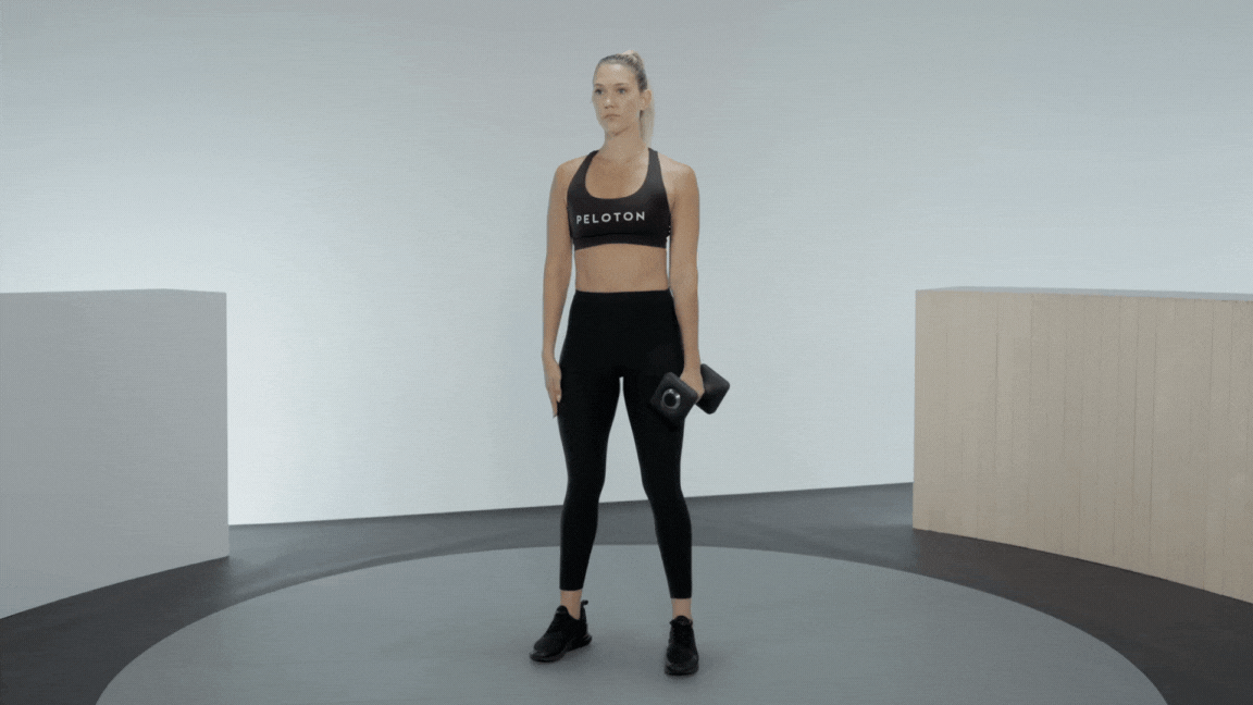 Peloton instructor Callie Gullickson demonstrates a dumbbell side bend oblique exercise